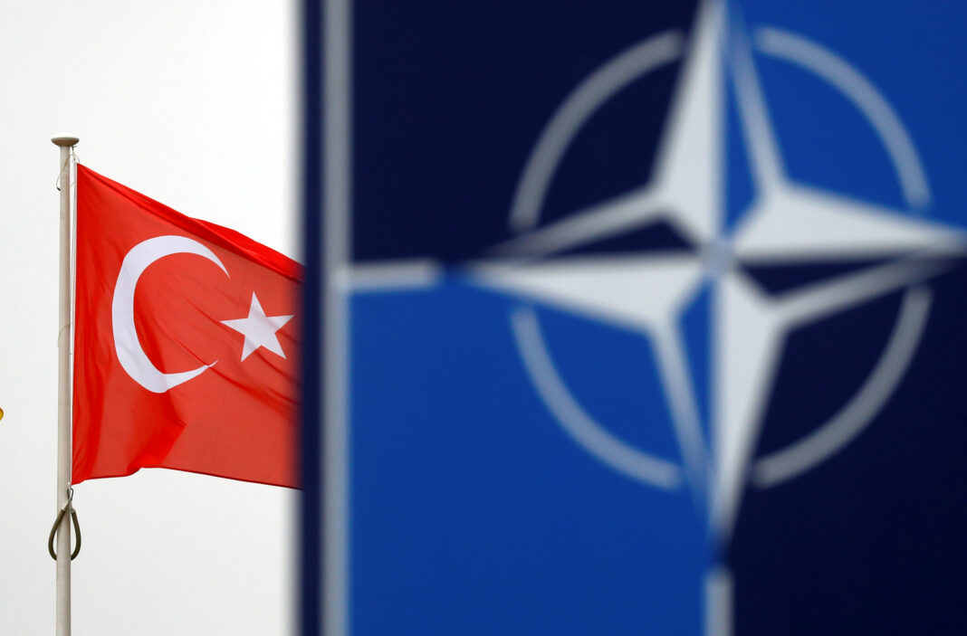 FILE PHOTO: A Turkish flag flies next to NATO logo at the Alliance headquarters in Brussels, Belgium, November 26, 2019. REUTERS/Francois Lenoir