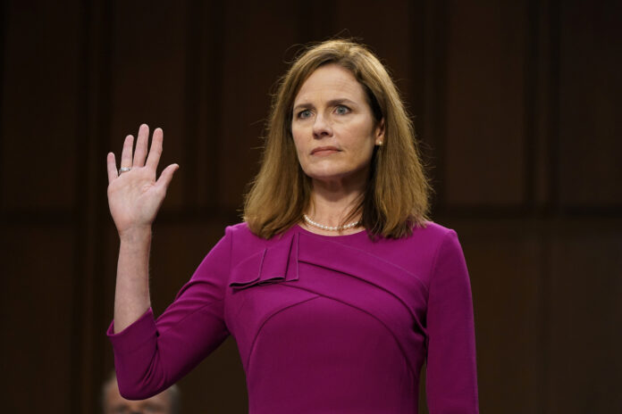 U.S. Supreme Court nominee Amy Coney Barrett is sworn in during her confirmation hearing before the Senate Judiciary Committee with her family on Capitol Hill in Washington , D.C., U.S., October 12, 2020. Patrick Semansky/Pool via REUTERS - RC26HJ93FK3P